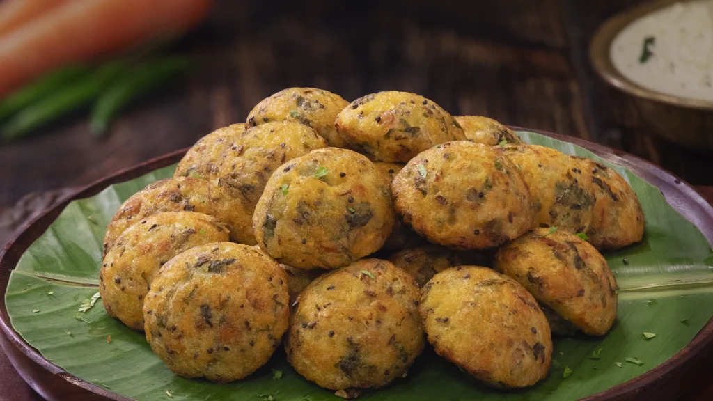 Easy Indian Picnic Menu Ideas: Recipes That Travel Well 12 A plate of crispy Rava Paniyarams served with coconut chutney.
