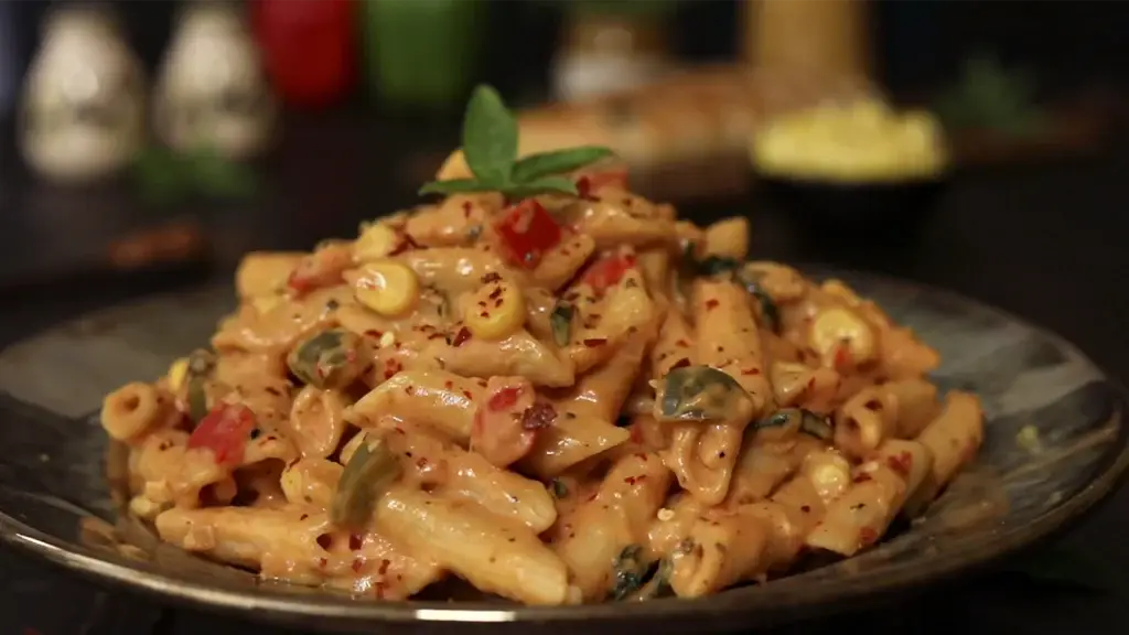 New Year Party Menu Ideas for a Perfect Celebration 14 Garnishing pasta with basil