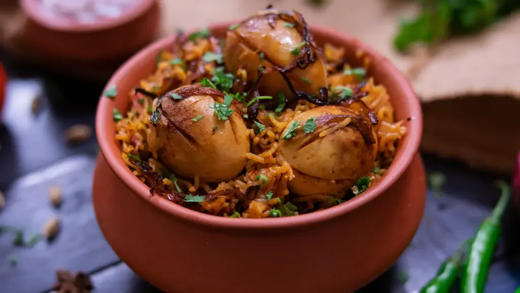 8 Delicious Egg Dishes to Try for Every Mood 8 A plate of egg biryani garnished with herbs