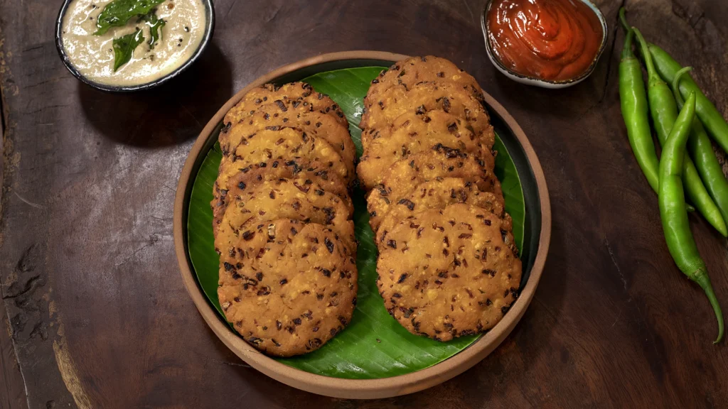 Easy Indian Picnic Menu Ideas: Recipes That Travel Well 13 A plate of golden brown Maddur Vadas served with chutney