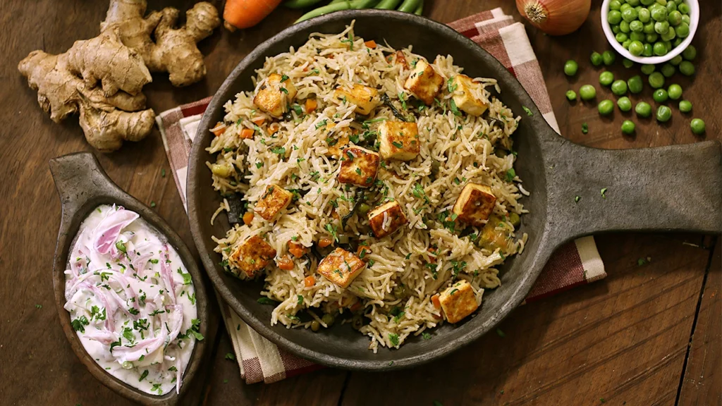 Paneer pulao served in a bowl with raita