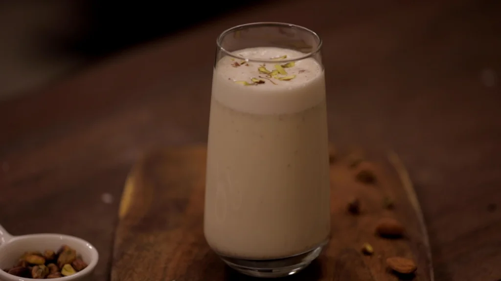 Lazy Mornings, Hearty Bites: Brunch Recipes to Brighten Your Day 50 A glass filled with pista badam milkshake, garnished with nuts