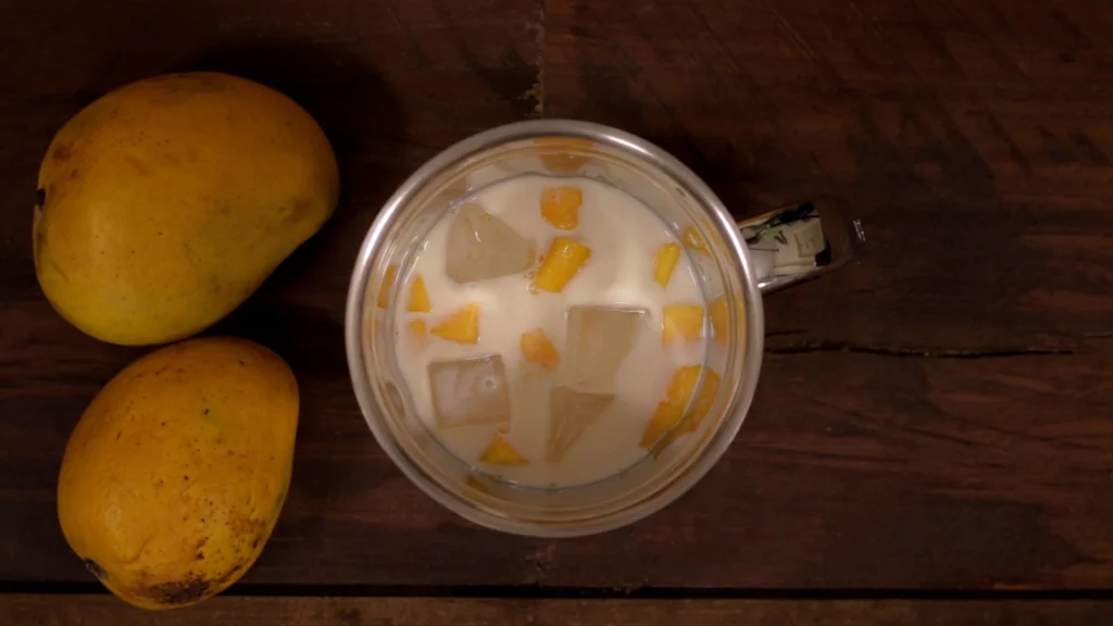 Lazy Mornings, Hearty Bites: Brunch Recipes to Brighten Your Day 43 Mango pieces, sugar, and milk in a blender jar