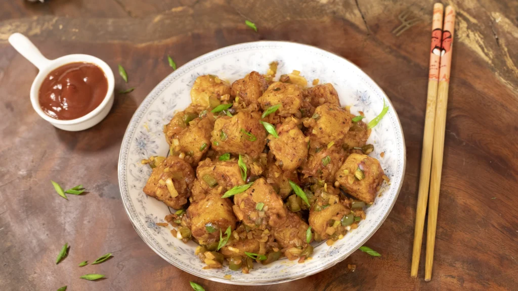 8 Irresistible Potato Dishes for Every Mood – From Breakfast to Dinner 8 A plate of garnished, saucy Aloo Manchurian ready to serve