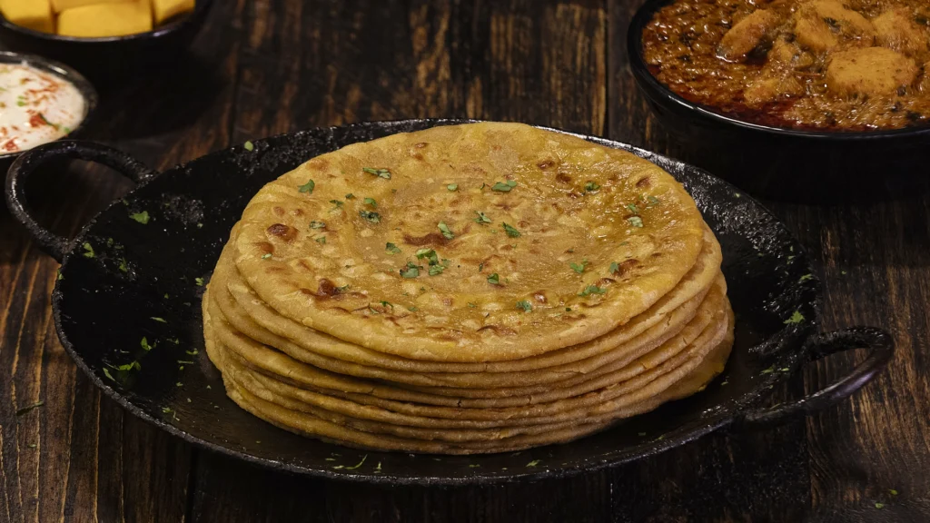 stack of pumpkin parathas on a plate