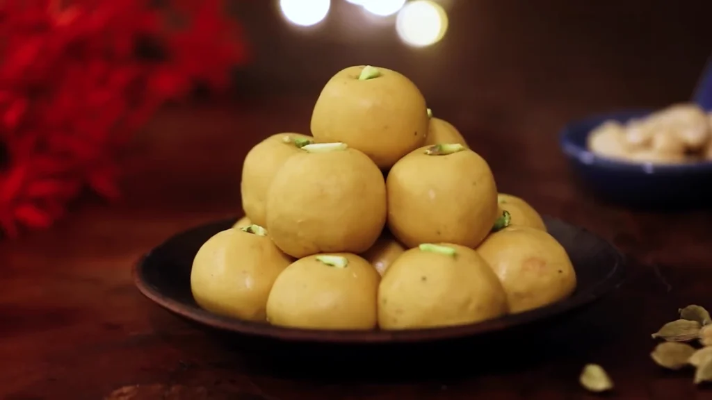 a plate of golden besan laddoos ready to serve